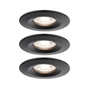 Three round recessed spotlights in matte black metal with warm white light for modern indoor lighting
