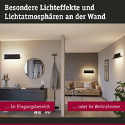 Modernes Wohnzimmer und Eingangsbereich mit schwarzen Wandlampen und warmem Licht für Wohnraumbeleuchtung