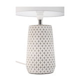 Table lamp with white fabric shade and grey ceramic base with star pattern for home lighting