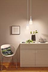 Modern white pendant lights with frosted glass above cream sideboard in living room with wooden floor