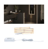 Warm white LED strip with power supply for indirect lighting in modern bathroom settings.