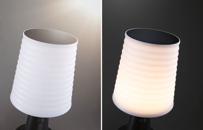 White ribbed plastic solar light with black solar panel, shown unlit and lit at night