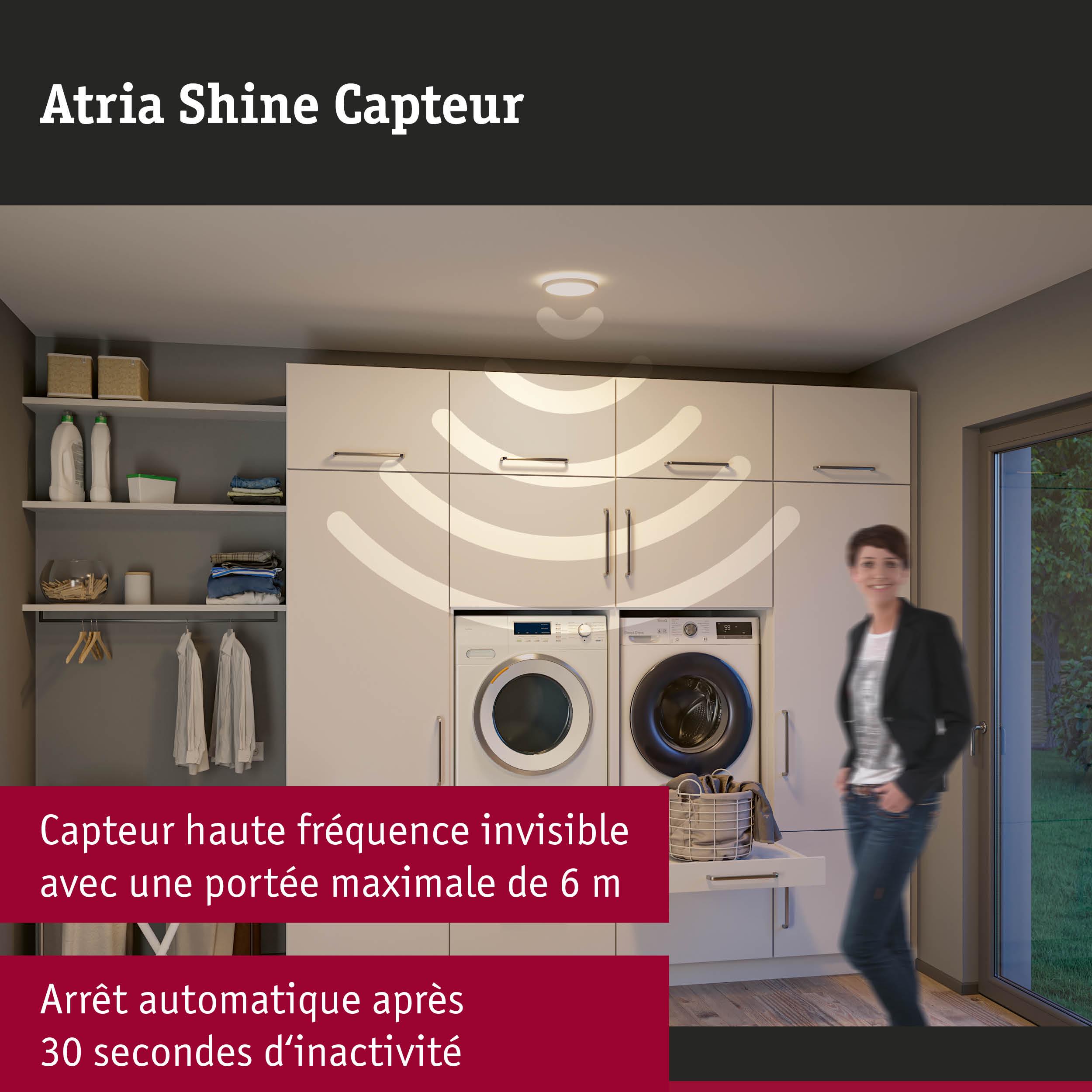 Buanderie moderne avec placards blancs, lave-linge, sèche-linge et capteur haute fréquence invisible de 6 m