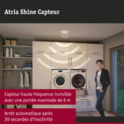 Spot de plafond blanc avec capteur dans une buanderie moderne avec machine à laver et sèche-linge