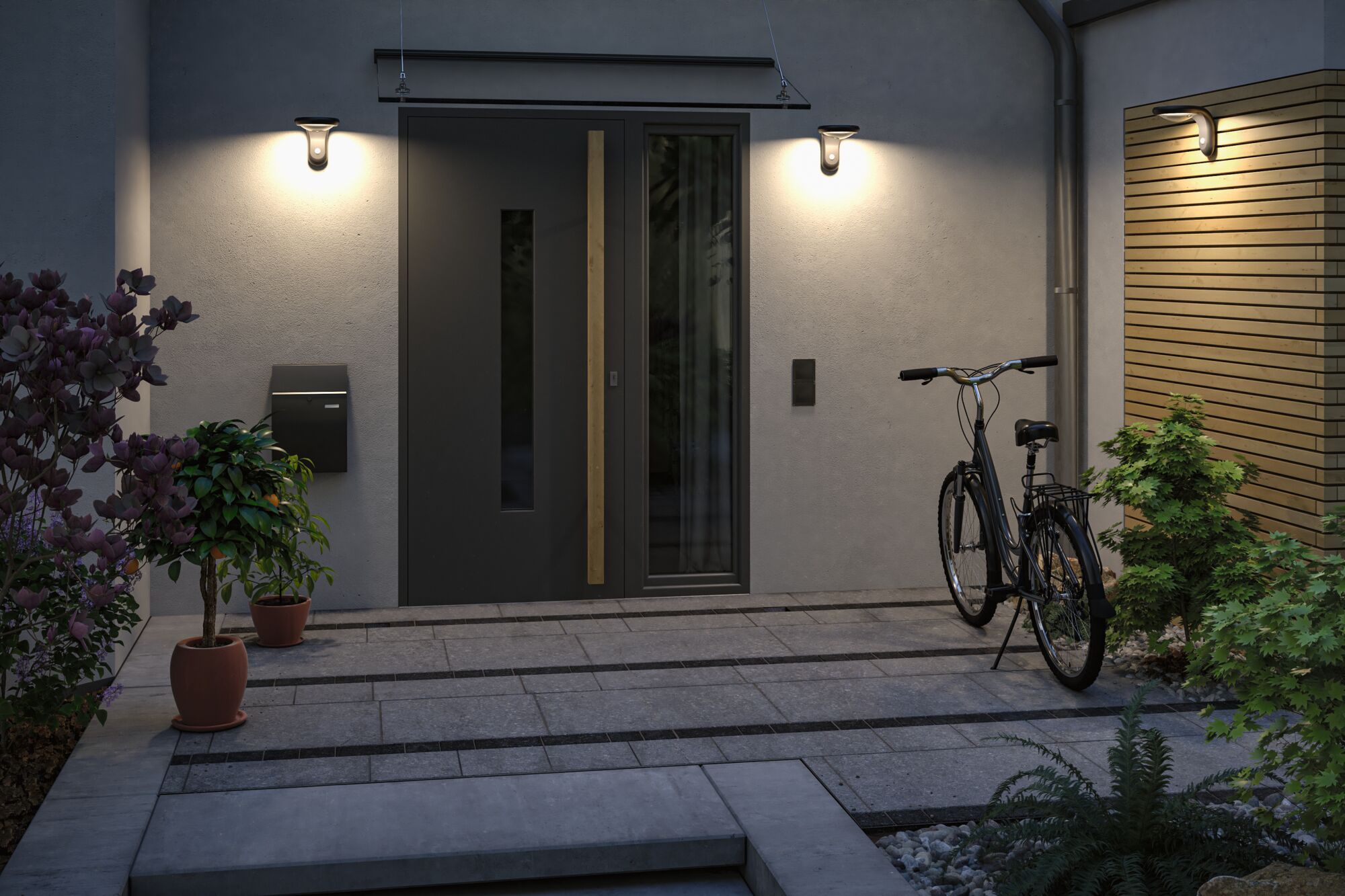 Éclairage extérieur moderne avec trois appliques murales blanc chaud sur la façade et l'entrée.