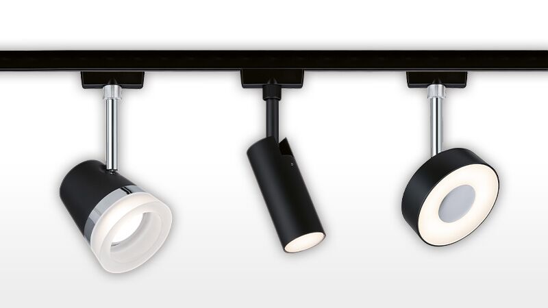 Drei schwarze URail LED-Schienenstrahler mit verschiedenen Designs und warmweißem Licht für moderne Innenbeleuchtung