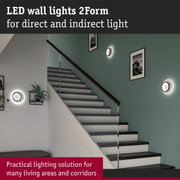 Modern white LED wall lights 2Form with black ring for direct and indirect lighting in stairway