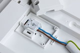 White plastic housing with electrical terminal block and brown, blue wires for LED lighting connection