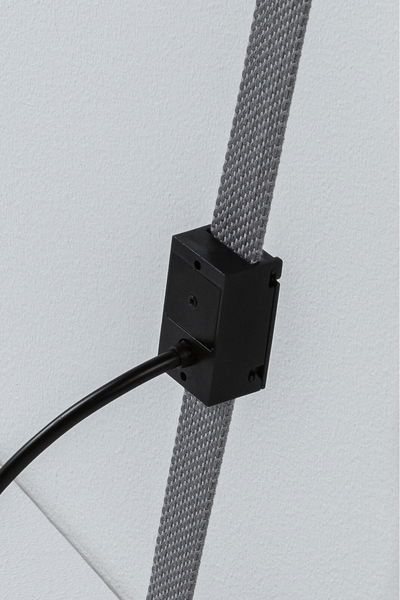 Black electrical connector box on grey textile cable for LED lighting systems