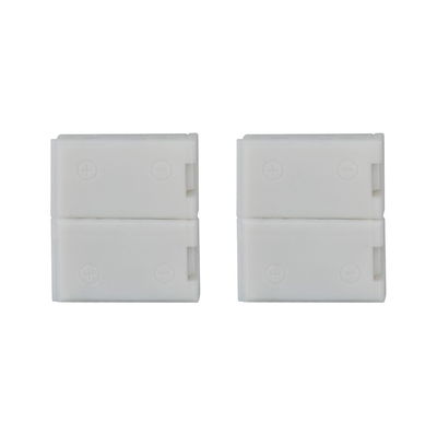 Two white plastic connectors with plus and minus symbols for LED lighting systems