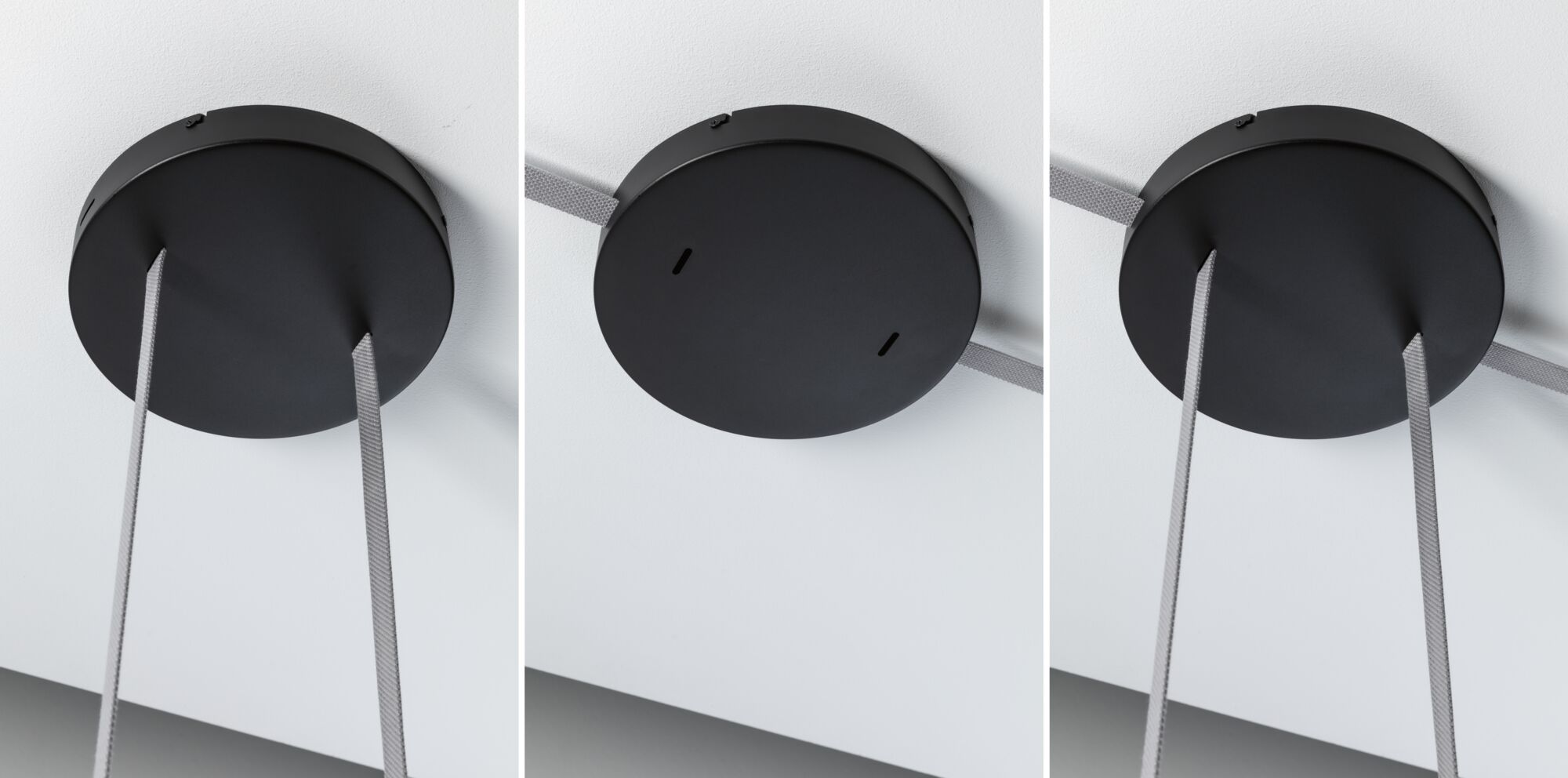 Schwarze runde Deckenbefestigung aus Metall mit grauen Textilkabeln für moderne Beleuchtungssysteme.