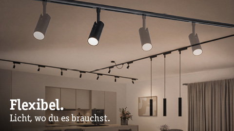 Modern black and white track spotlights on ceiling in living room with flexible lighting solution.