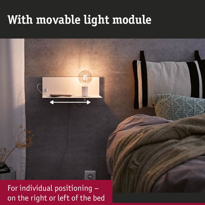 White wall lamp with movable light module and shelf beside bed with grey wall and knitted blanket