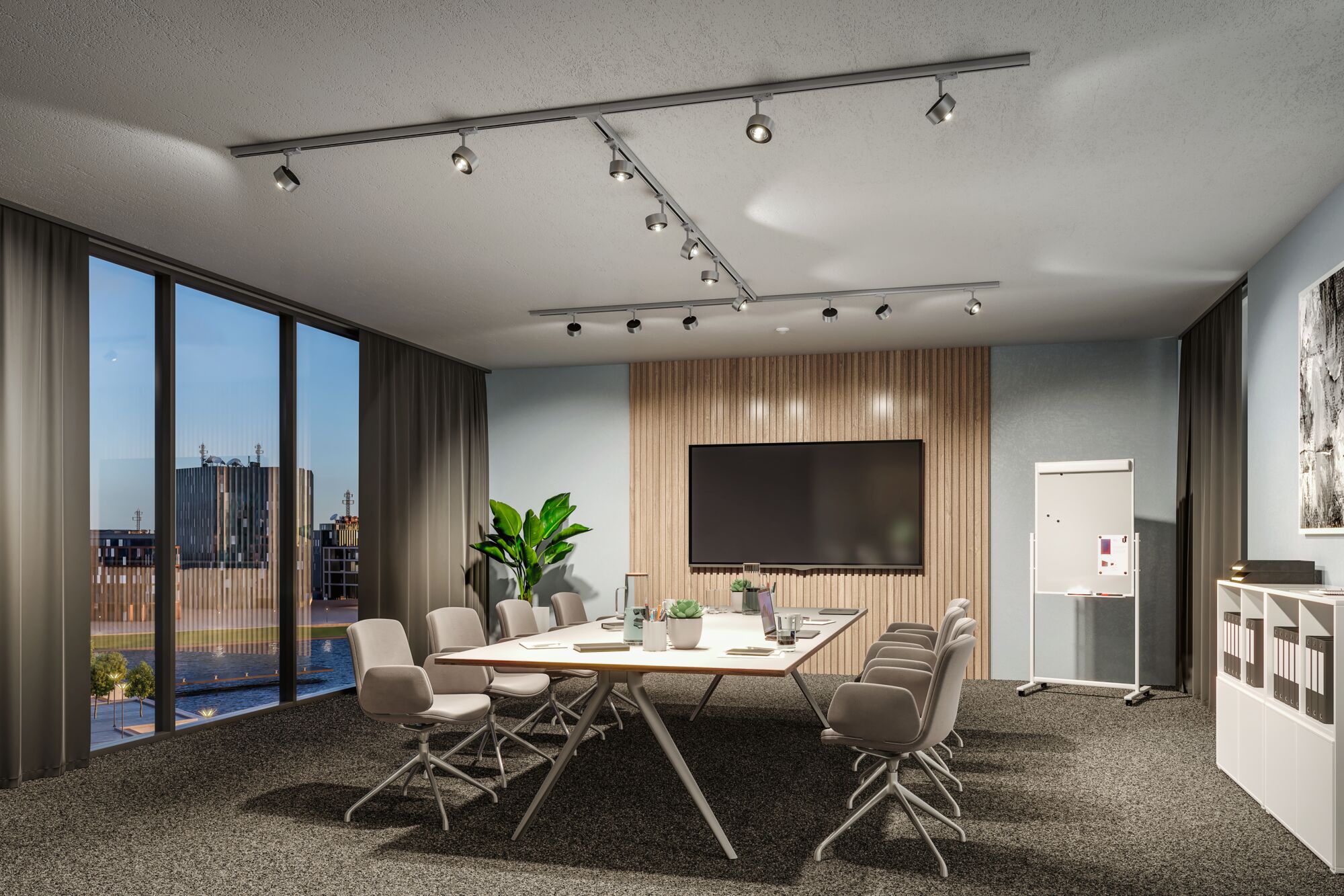 Modern conference room with grey chairs, large table, and adjustable silver ceiling spotlights.
