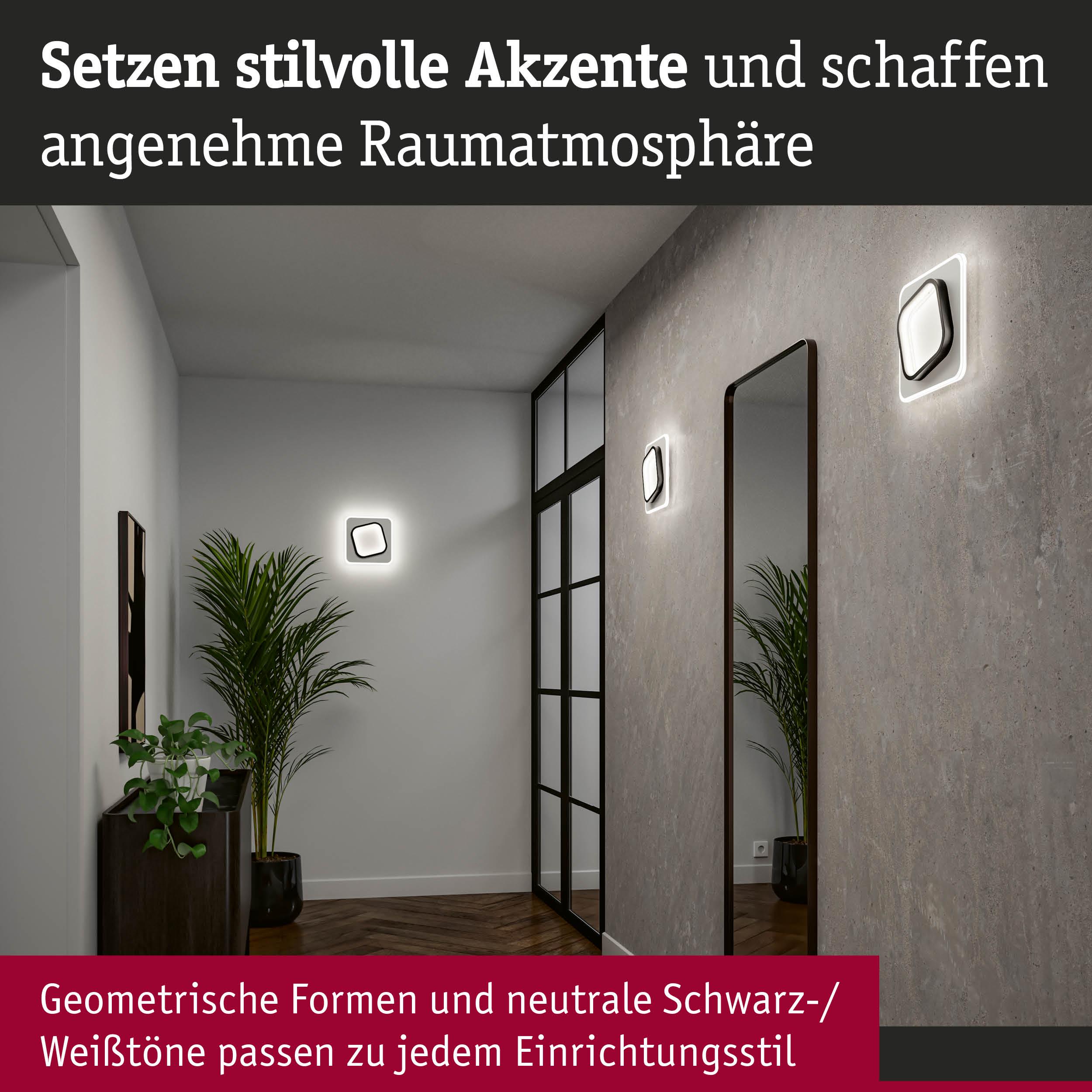 Moderne Wandlampen in Schwarz-Weiß mit geometrischem Design schaffen stilvolle Akzente im Flur.