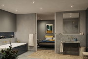 Modern bathroom with grey tiles, bathtub, sink, and recessed lighting for ambient home lighting.