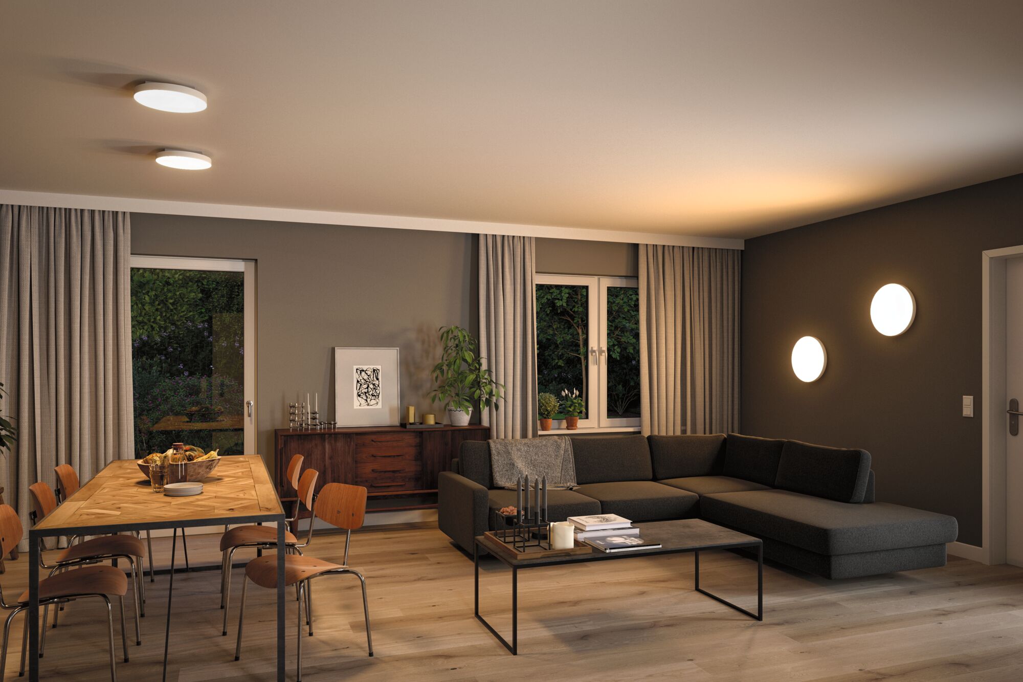 Modern living room with round white LED ceiling and wall lights, wooden dining table and grey sofa