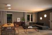 Modern living room with round white LED ceiling and wall lights, wooden dining table and grey sofa