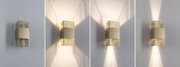 Moderner goldfarbener Metall-Wandleuchter mit Gitterdesign und variabler Lichtstreuung an weißer Wand