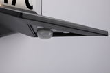 Black LED light panel with integrated motion sensor made of plastic for indoor use.