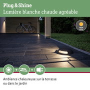 Lumière extérieure de jardin avec éclairage blanc chaud sur terrasse en matériau noir pour ambiance