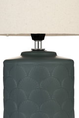 Table lamp with dark green ceramic base and cream fabric shade for home lighting