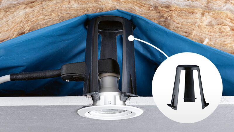 Black plastic mounting bracket for recessed lights installed in ceiling with cable connection, lighting accessory.