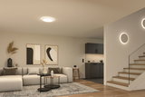 Moderne stue med rund loftslampe og varm hvid LED-væglamper, trætrappe og grå sofa