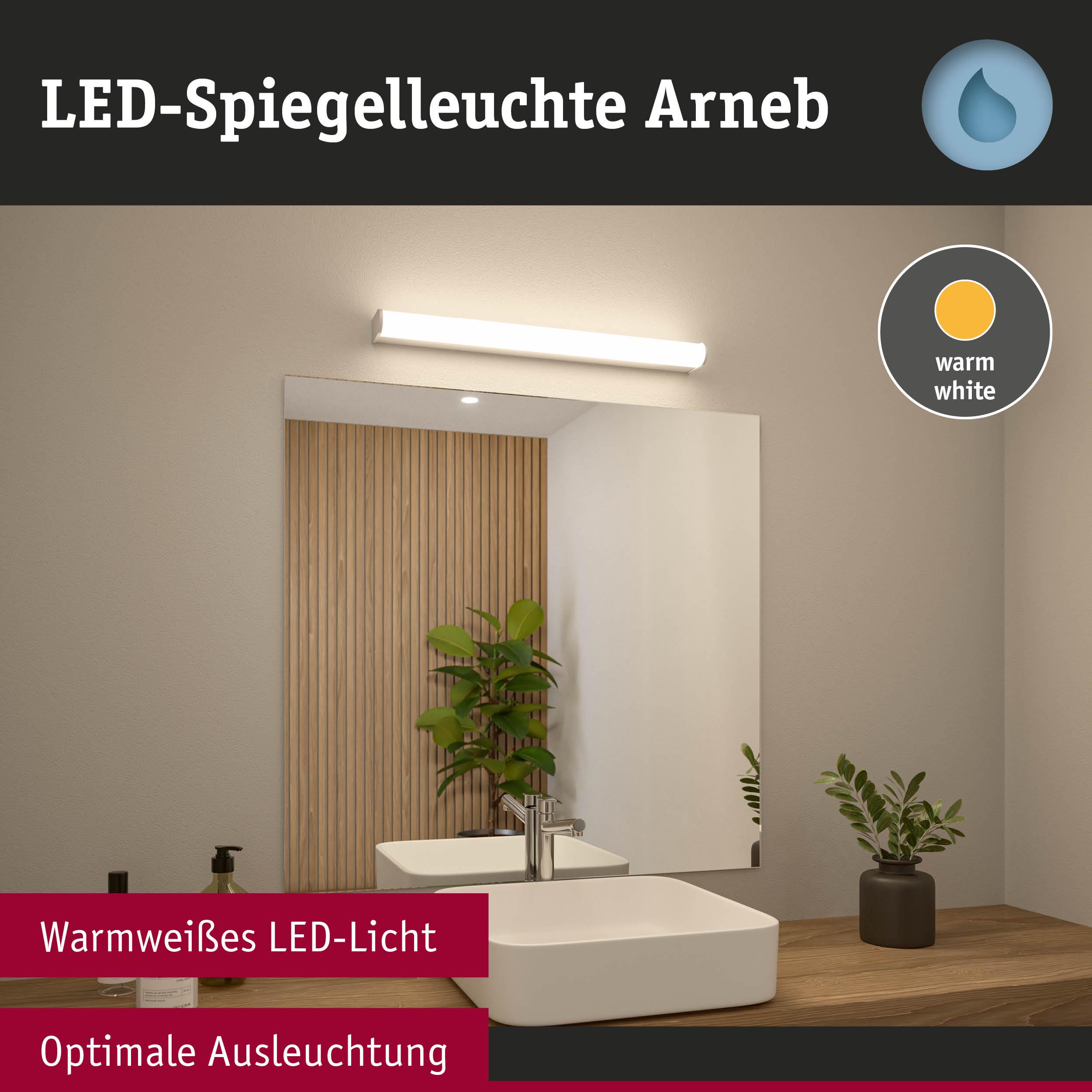 LED-Spiegelleuchte Arneb mit warmweißem Licht über weißem Waschbecken und Holzablage im Bad