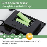 Black device with two replaceable green lithium-ion batteries for reliable energy supply