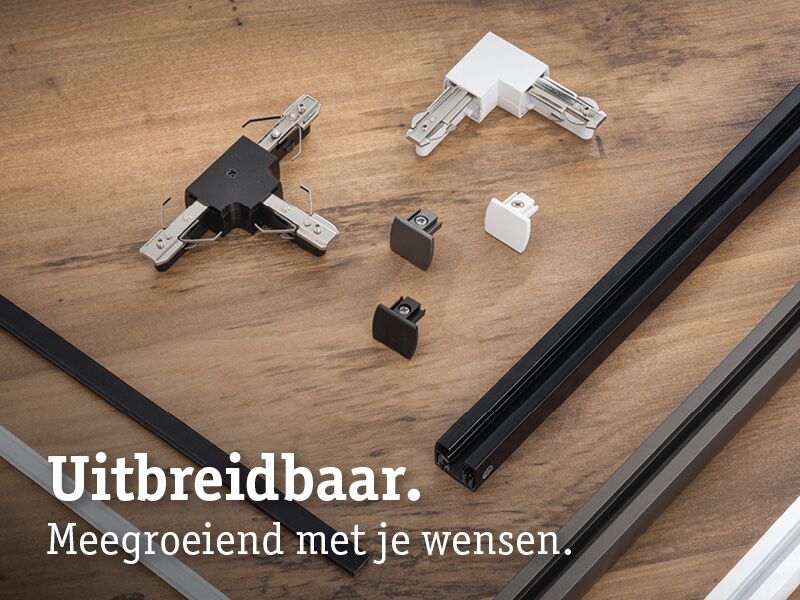Modulaire zwarte en witte metalen en kunststof railverbindingen op houten ondergrond voor uitbreidbare railsystemen