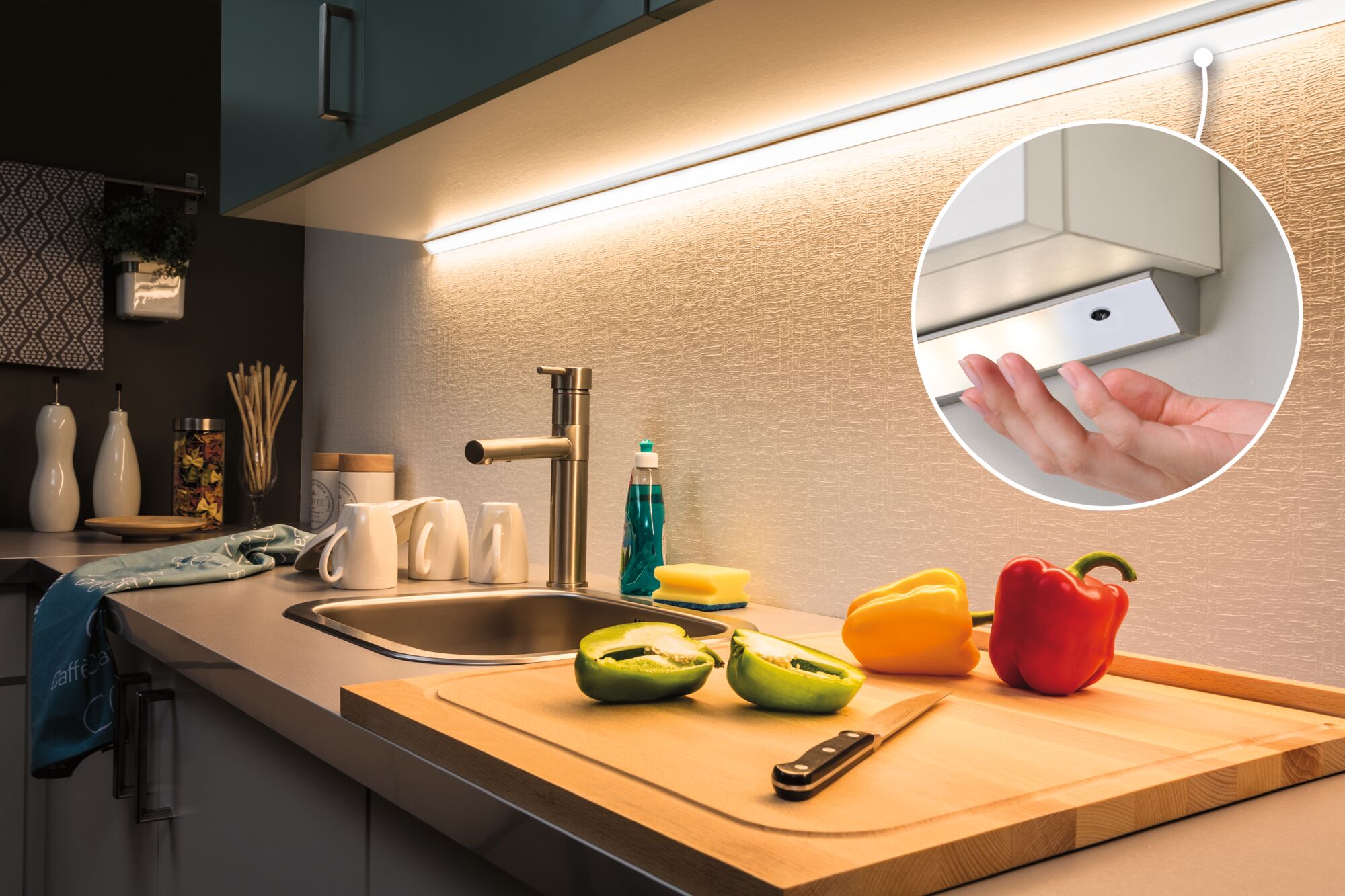 White LED under-cabinet light with warm white glow above kitchen sink and cutting board with peppers
