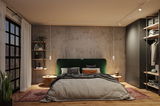 Modern bedroom with green fabric headboard, concrete wall, warm wooden floor and ambient lighting