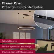 Retractable black channel cover protects suspended lighting system from dust and damage