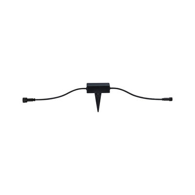 Black plastic connector with ground spike and cables for outdoor lighting systems.
