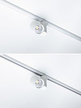 Moderner weißer LED-Strahler aus Metall an Schienensystem für flexible Raumbeleuchtung