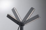 Black metal LED floor lamp with adjustable head for flexible lighting in living spaces