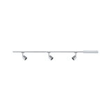 Three silver metal LED spotlights on straight rail system for modern interior lighting