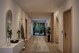 Modern hallway with wood flooring, white walls, wooden doors and recessed LED spotlights in ceiling