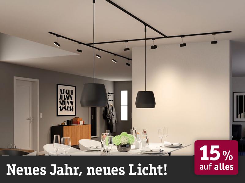 Modern dining room with black pendant lights and LED track lighting, stylish interior lighting design.