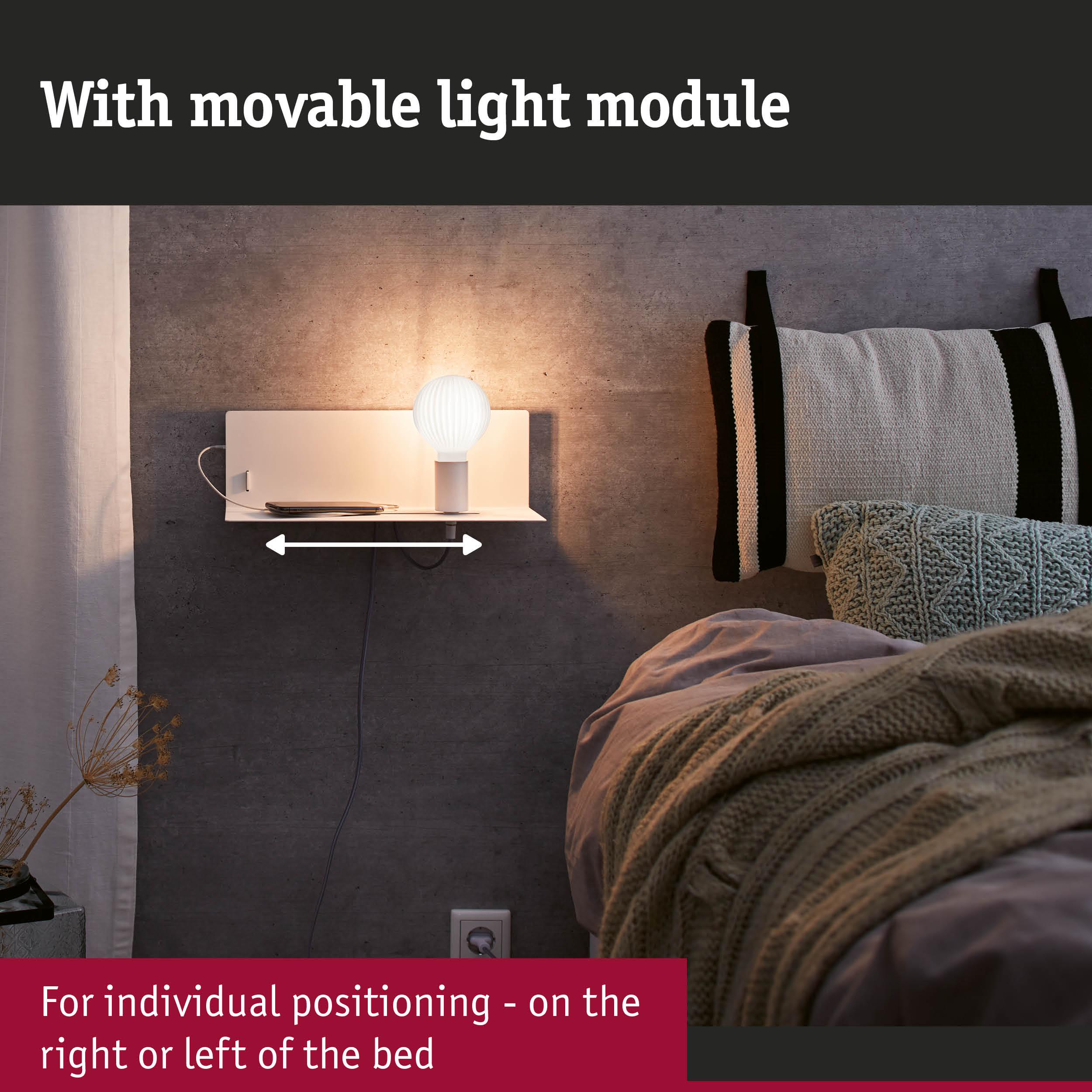 White wall lamp with movable light module and shelf next to bed with grey wall and cushions