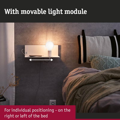 White wall lamp with movable light module and shelf next to bed with grey wall and cushions