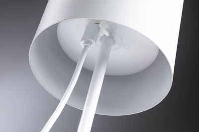 Close-up of white metal ceiling lamp with cable connection and simple design