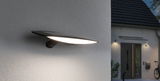 Black LED outdoor wall light with wide beam mounted on house wall for modern exterior lighting