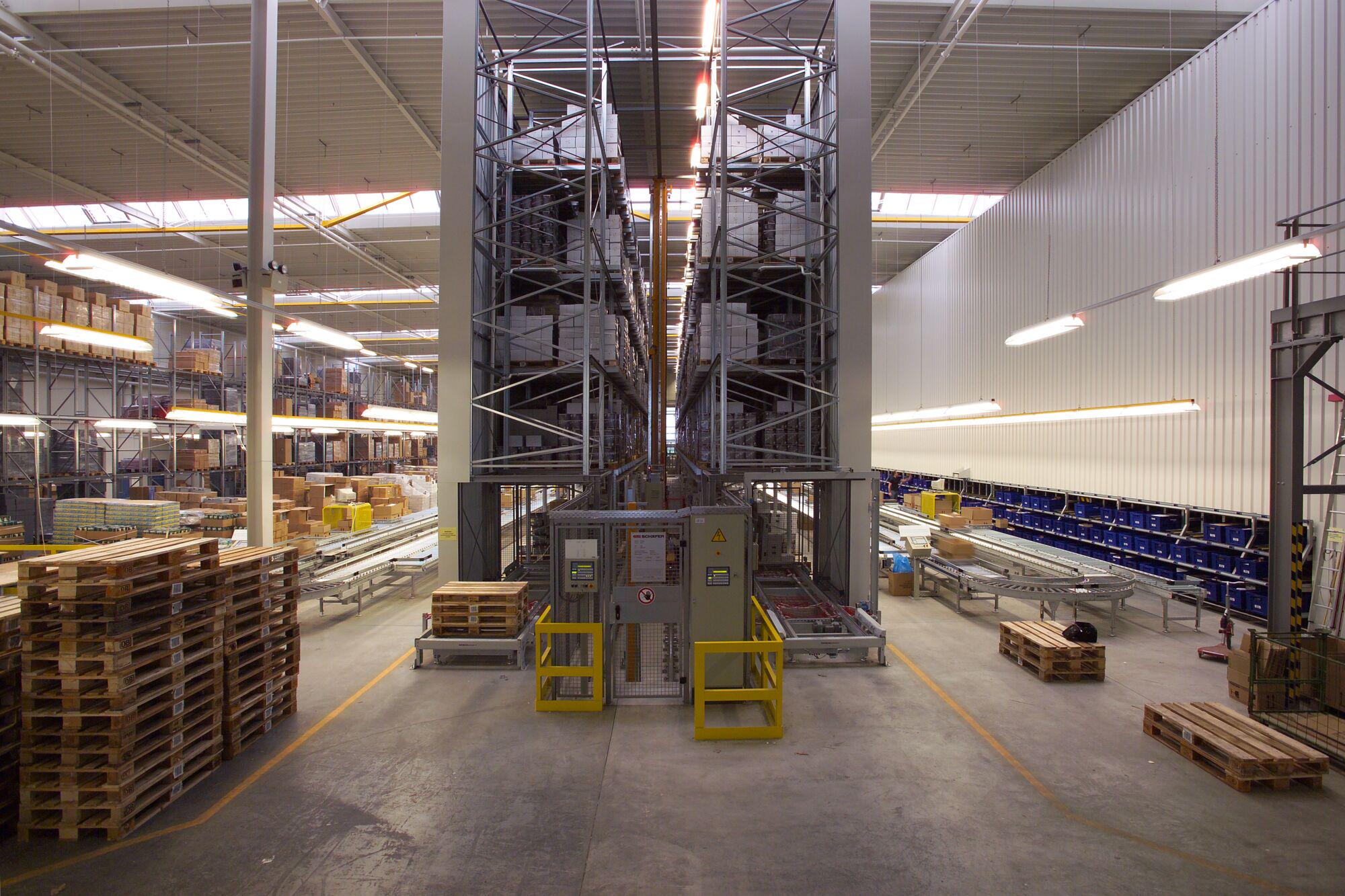 Large warehouse with automated high rack and conveyor belts for efficient logistics.