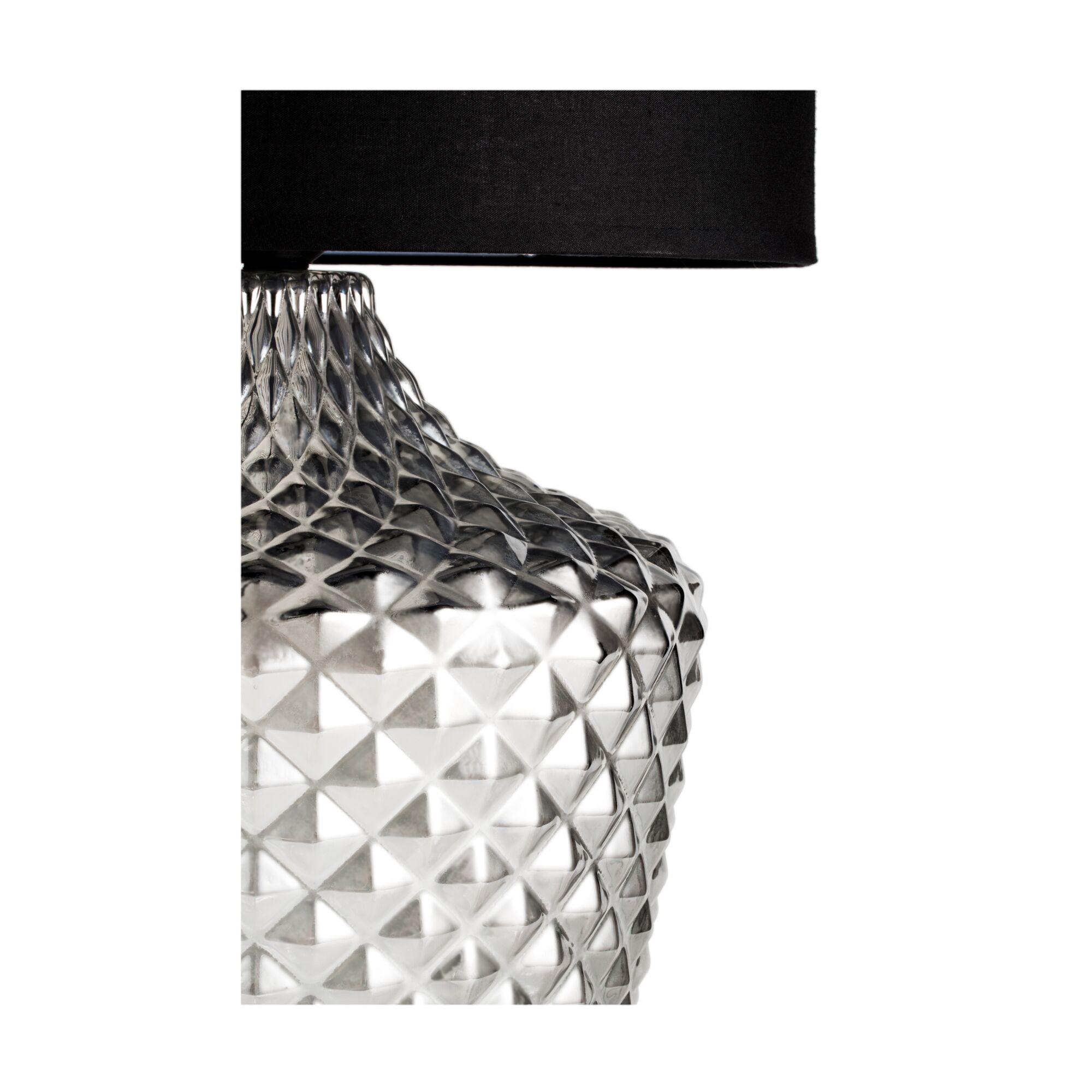 Table lamp with clear textured glass base and black fabric shade for elegant lighting