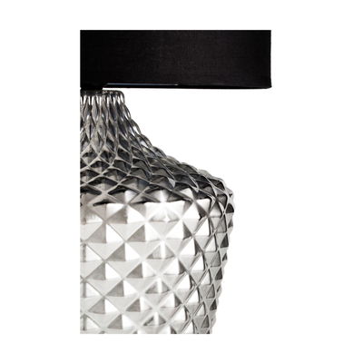 Table lamp with clear textured glass base and black fabric shade for elegant lighting