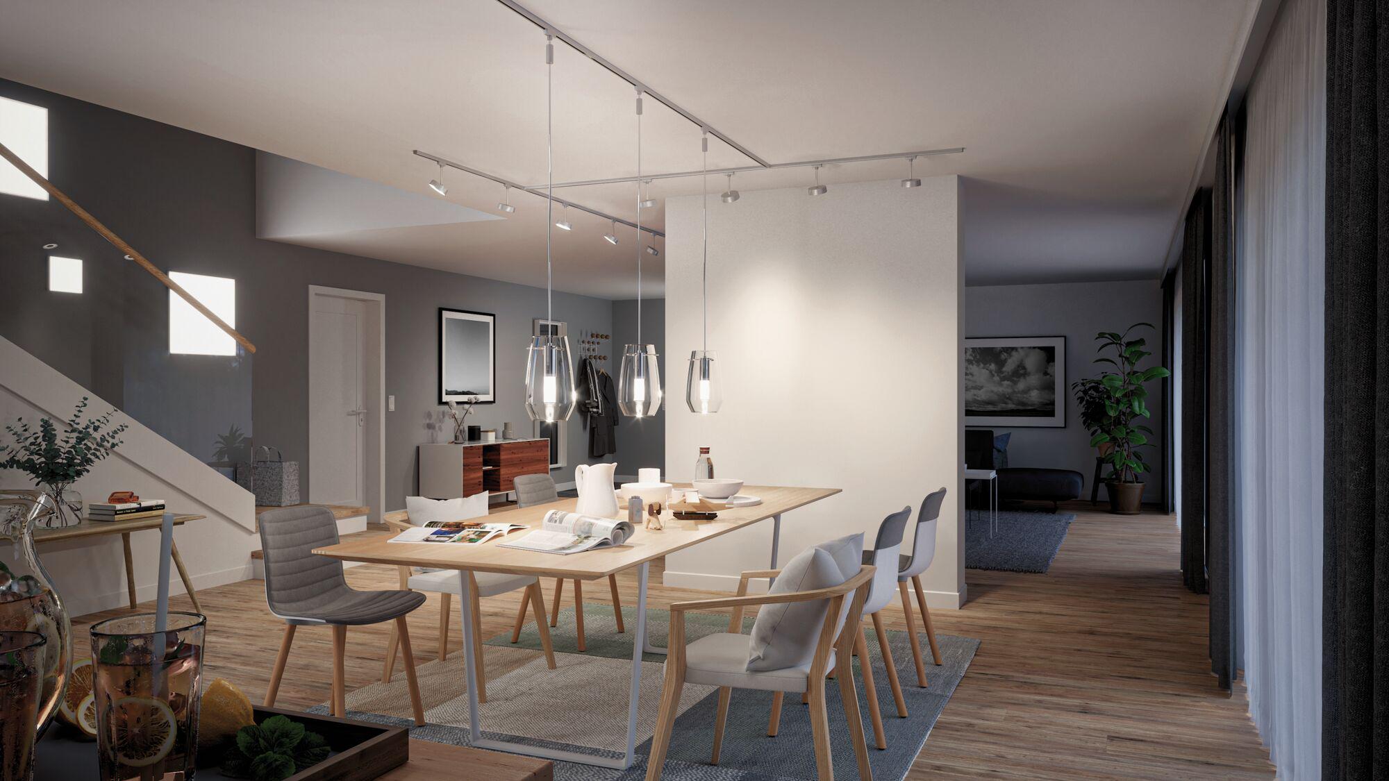 Modern dining area with wooden table, grey and white chairs, and Paulmann LED glass pendant lights.