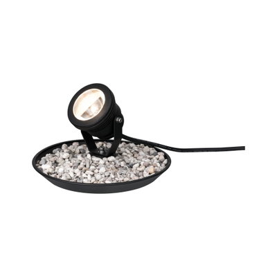 Black LED outdoor spotlight with adjustable head on gravel in round base for garden lighting