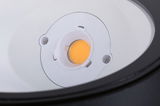 Close-up of white LED light source with orange bulb inside lamp housing for lighting solutions